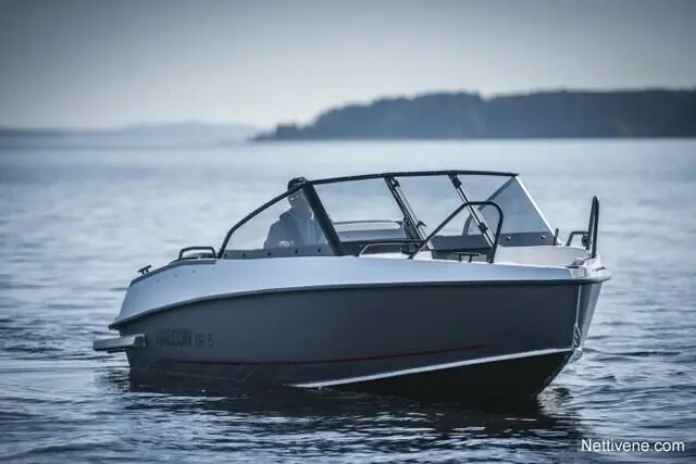 A sleek Falcon GR5 boat glides across calm waters with a driver visible at the helm and distant land in the background.